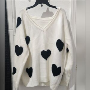 Large cream colored sweater with black hearts